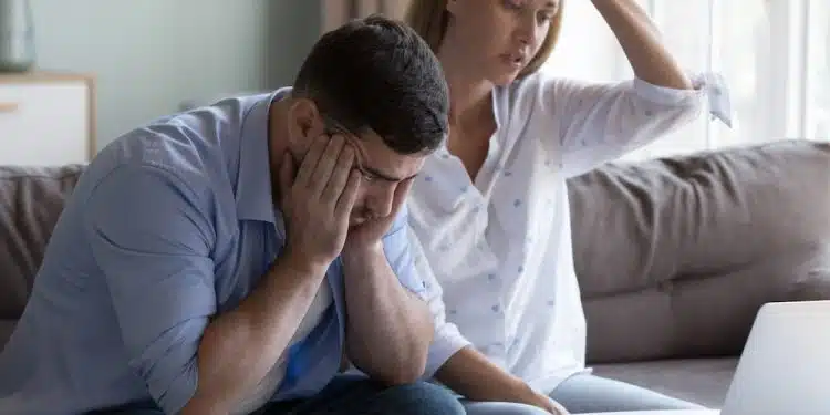 Stressed spouses manage family finances, analyze expenses, check savings and budget, looks disappointed due to mortgage arrears, unpaid utility bills, debt notice. Lack of money, high utility concept